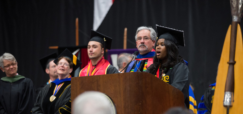 A student speaking at undergraduate commencement