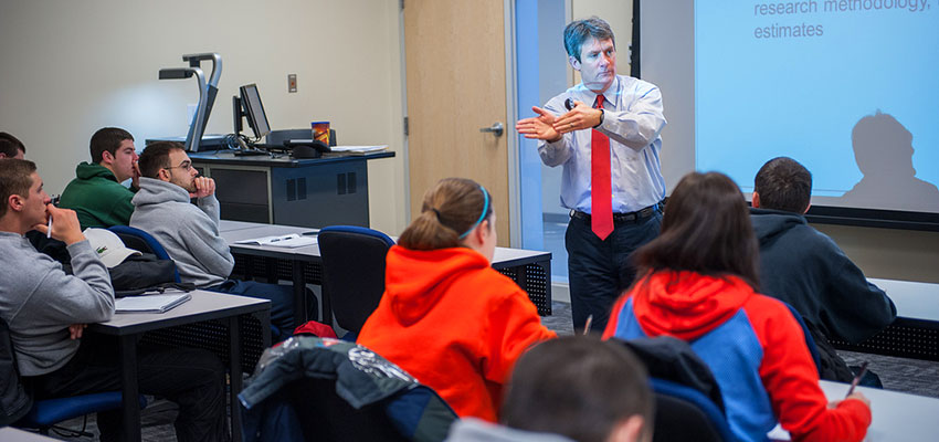 An instructor leads a sports management class lecture