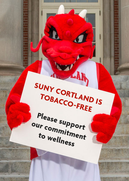 Blaze holds a sign saying "SUNY Cortland is tobacco-free. Please support our commitment to wellness."