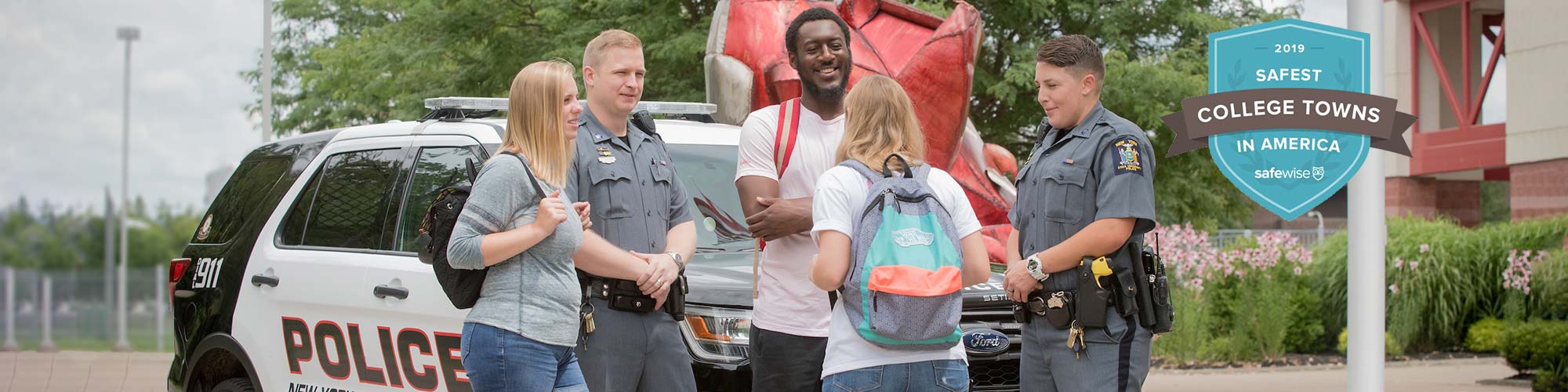 UPD officers speak with students in front of the Red Dragon statue