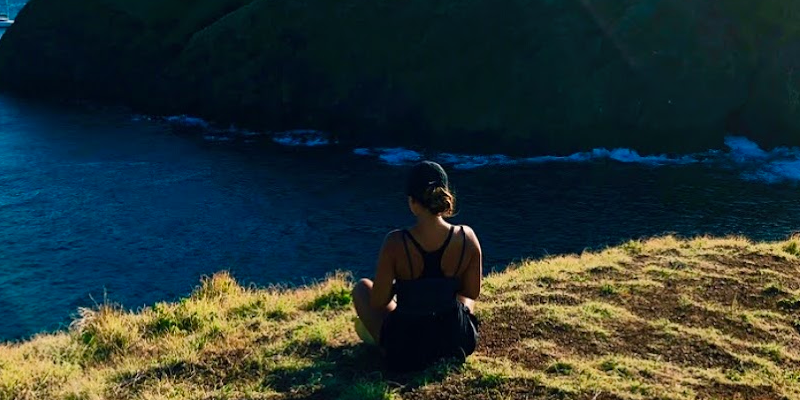Student sitting on a hill in Guanacaste, Costa Rica