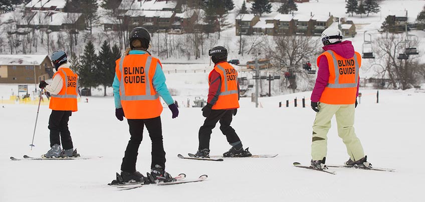 Guides help people who are blind learn to ski
