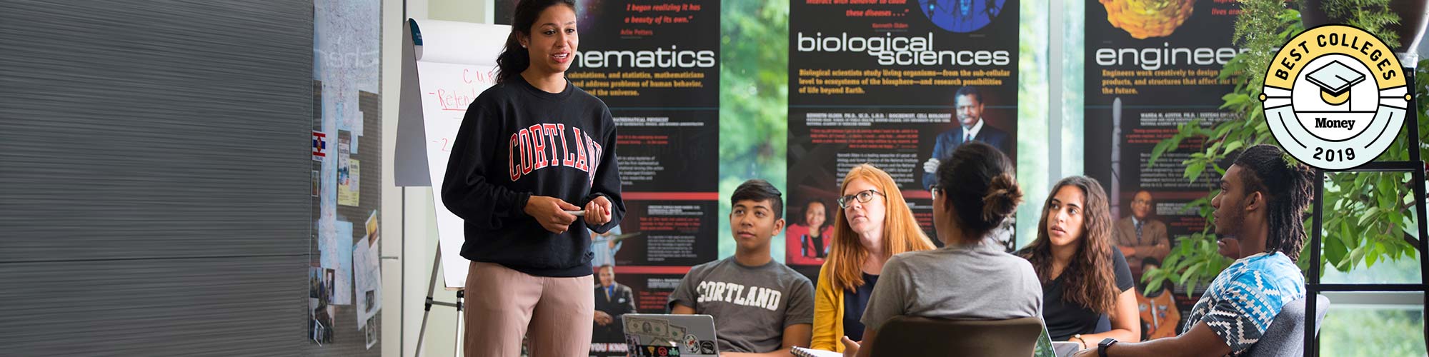 Students and faculty listen to a student presentation