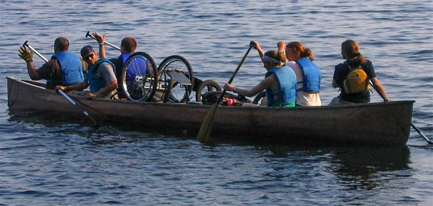 students and wheelchair in canoe