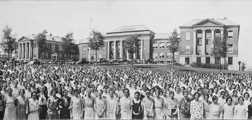 Commencement photo from the 1920s with Old Main in the background