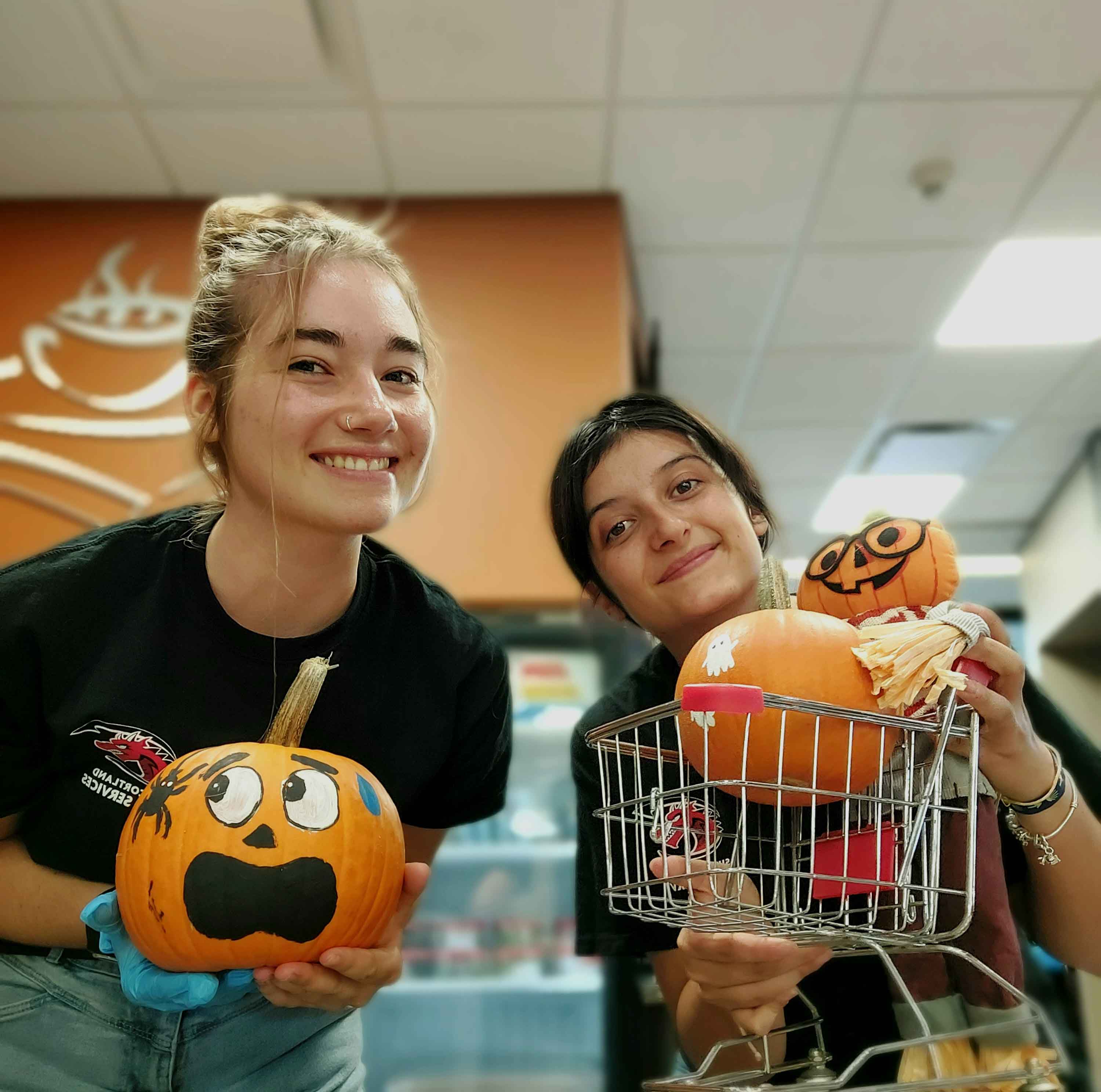 Students working at the Bookmark Cafe with pumpkins