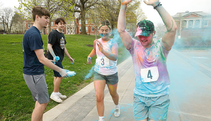 Color run participants covered in dusty colors