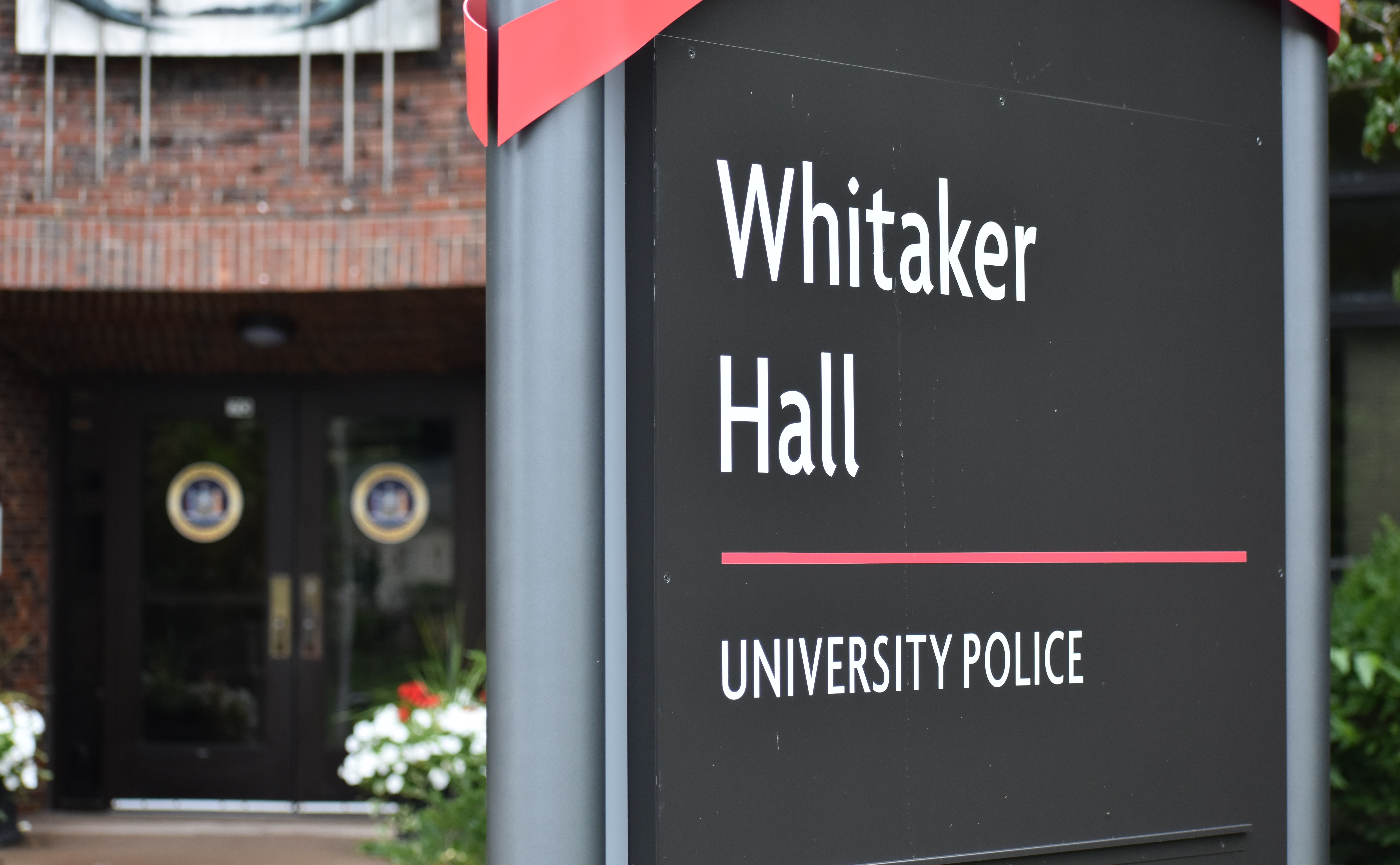 A sign on campus that reads "Whitaker Hall, University Police"