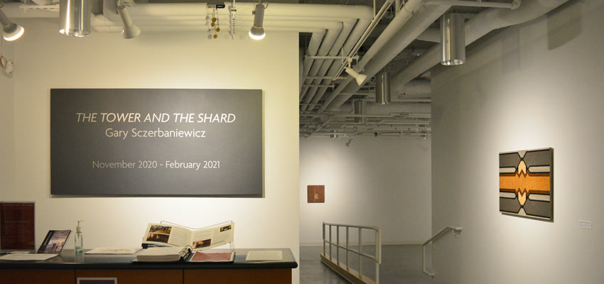 View of the welcome desk in front of the exhibit banner.