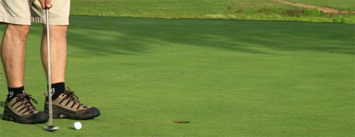Person putting a golf ball