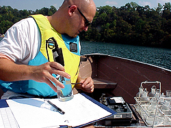Photo of a student collecting water sample data