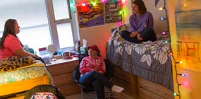 Students hanging out in residence hall room