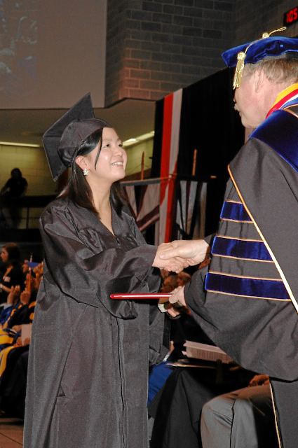 Student receiving diploma cover