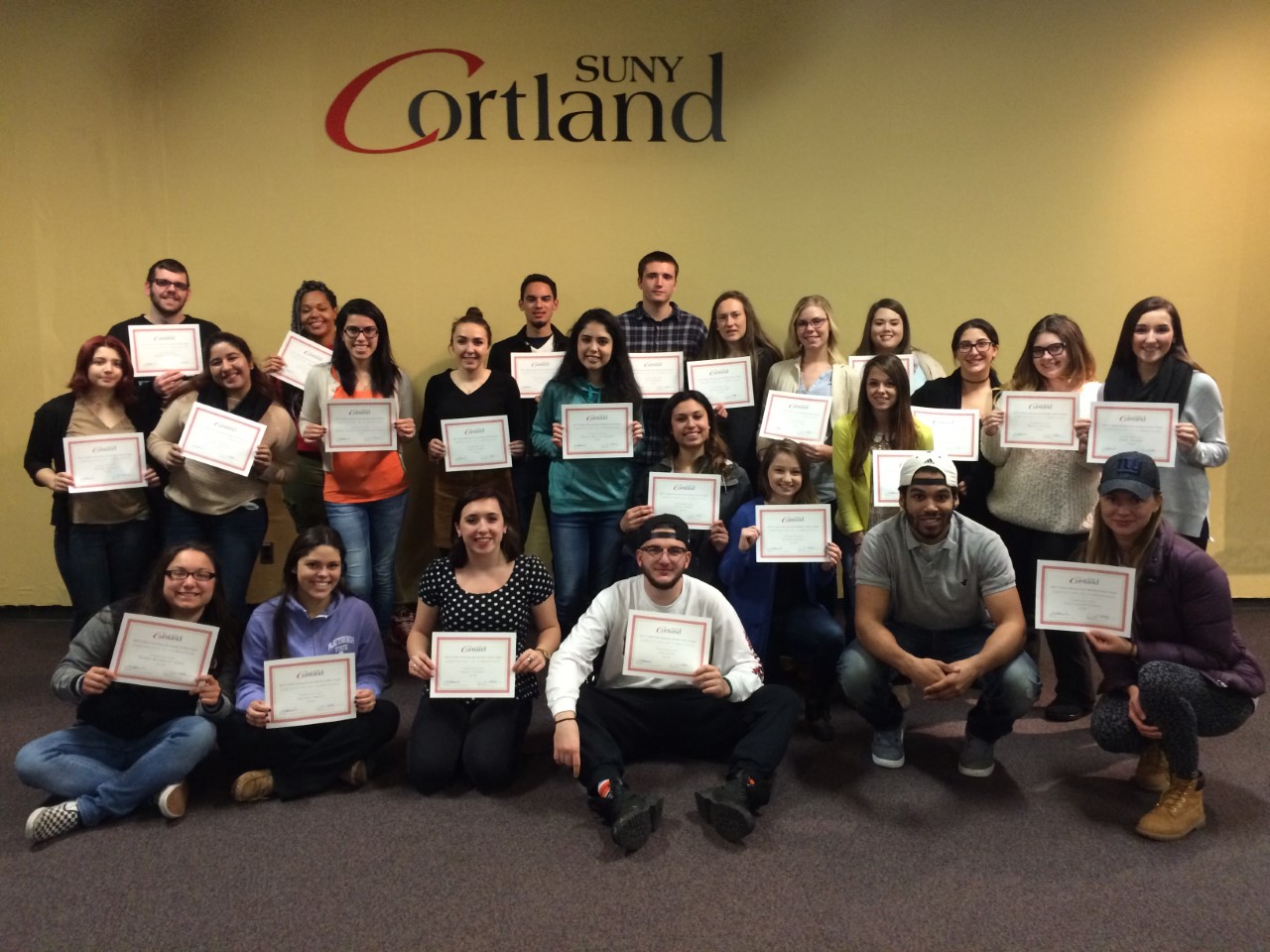 Students hold up certificates for completing Leadership Series