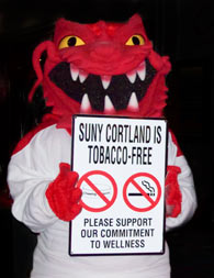 Blaze holding "SUNY Cortland is Tobacco-Free - Please support our commitment to wellness" sign.