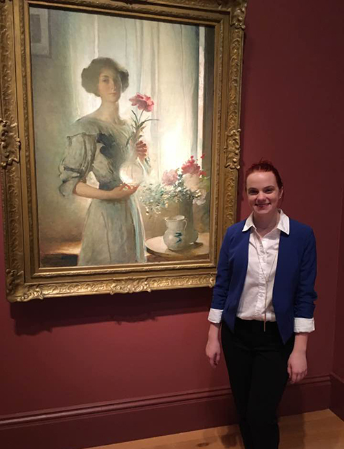 Claire Leggett stands in front of a painting at the Smithsonian National Portrait Gallery.