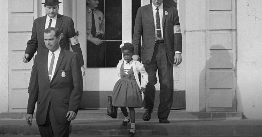 Young Ruby Bridges surrounded by US Marshals on school steps