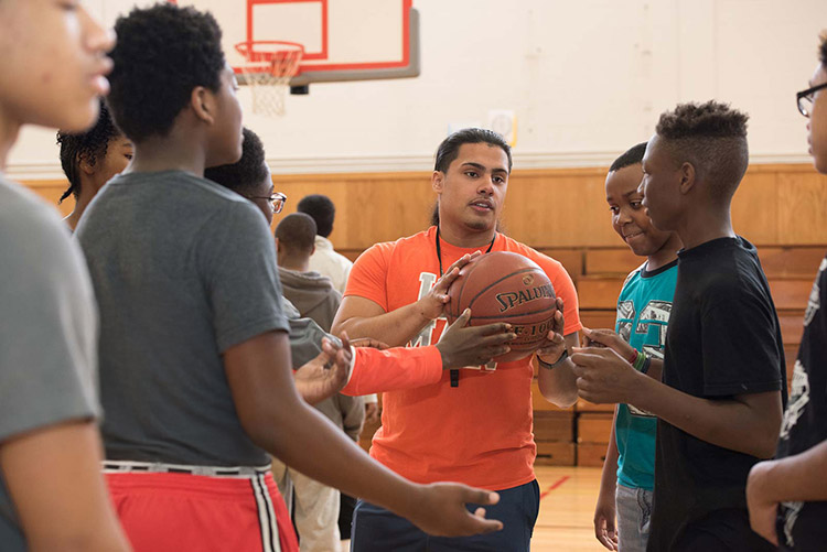 physical education teacher instructing young students