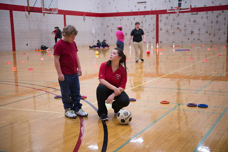 physical education teacher instructing young students