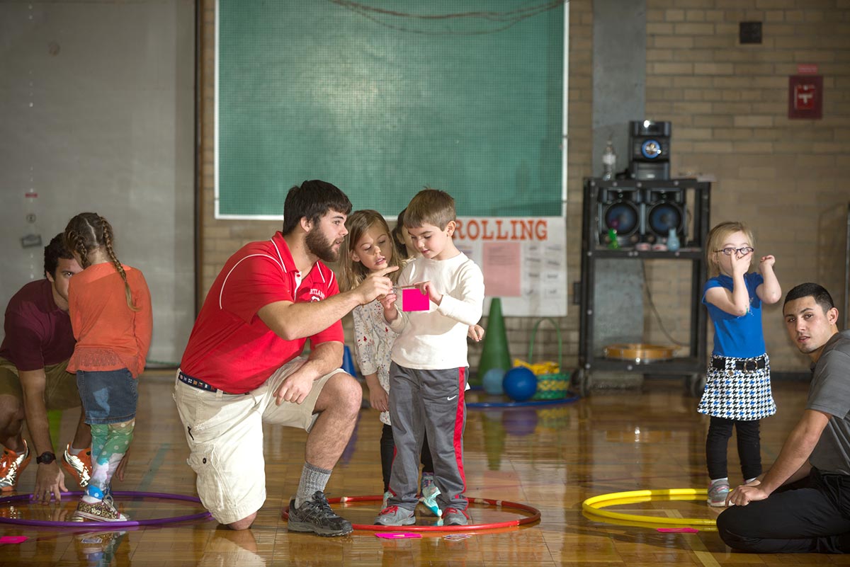 physical education teacher instructing young students