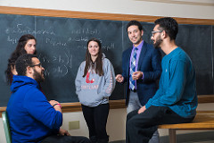 Students and professor chatting in classroom