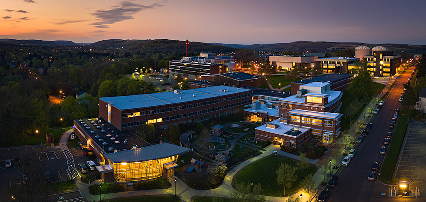 Aerial view of middle of campus, including Van Hoesen Hall and Education Building, during the early evening