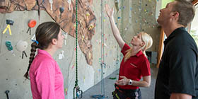 Professor and students at the climbing wall