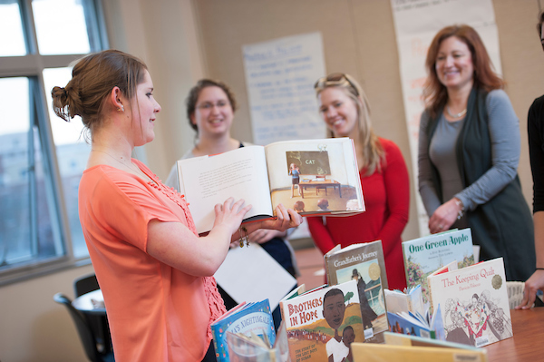 teacher reading book to students