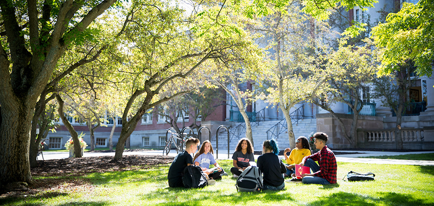 Students sitting on lawn outside of Old Main