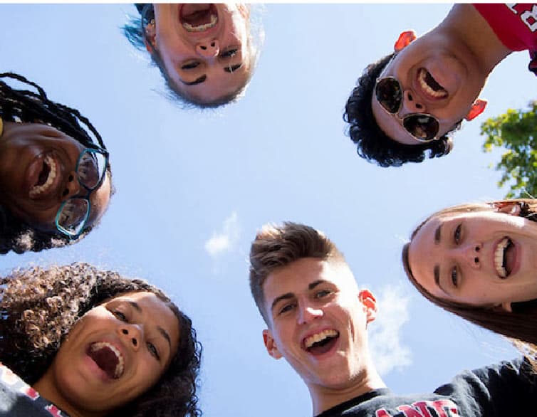 Students looking down a camera - We are all in