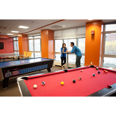 Students playing billiards in the Alger Hall Rec Lounge