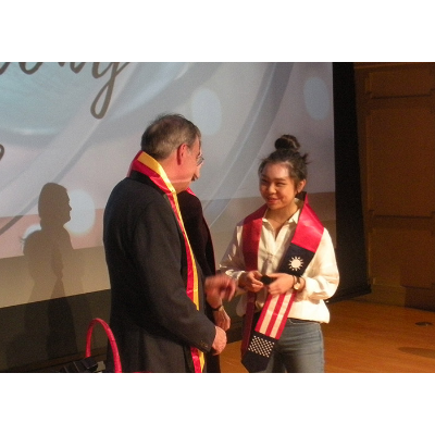 Student receiving Chinese sash
