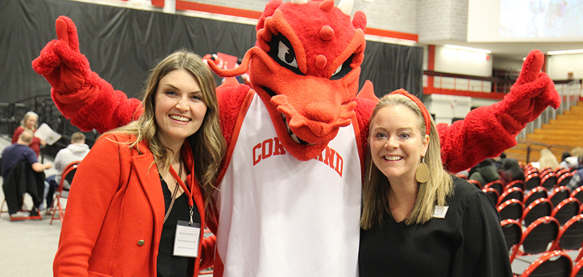 Out-of-state regional representatives Alyssa Ackerman and Shannon Wing with Blaze the red dragon mascot