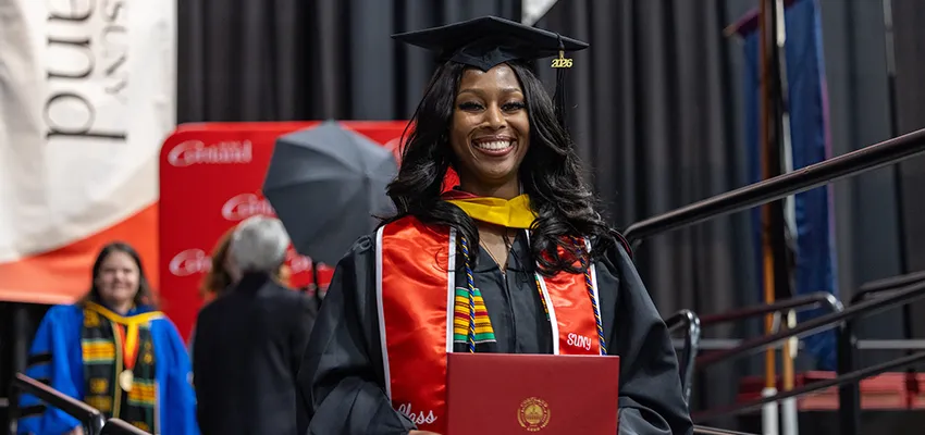 graduate student after receiving diploma at commencement