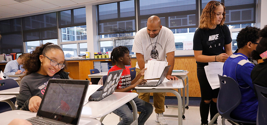 Photo of high school classroom with a SUNY Cortland student in his field placement
