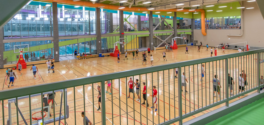 Students playing basketball in the indoor Student Life Center court