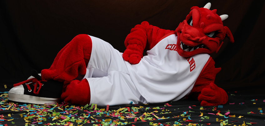 Blaze the Red Dragon mascot laying down