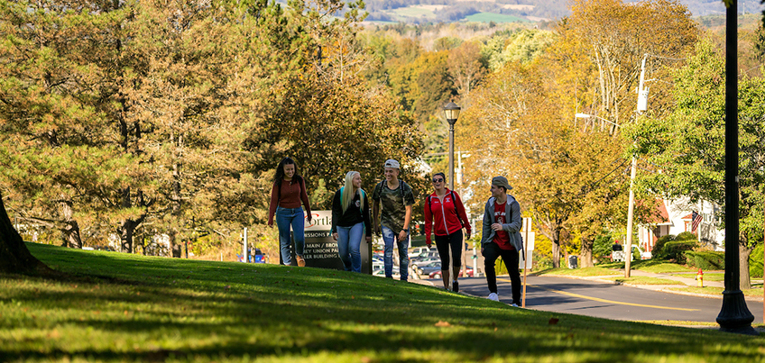 Students walking up the hill outside of Miller Building