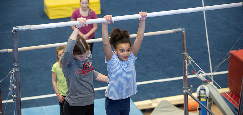 Cortland gymnastics team works with children in the community at Girls' Night Out