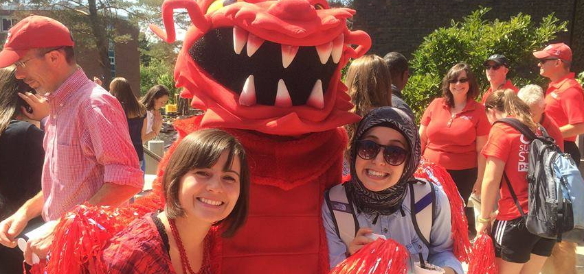 Students standing outside with Blaze, the SUNY Cortland dragon mascot