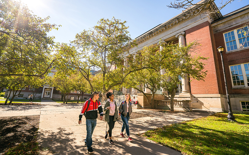 Students walking outside Old Main on a sunny day in Fall 2017