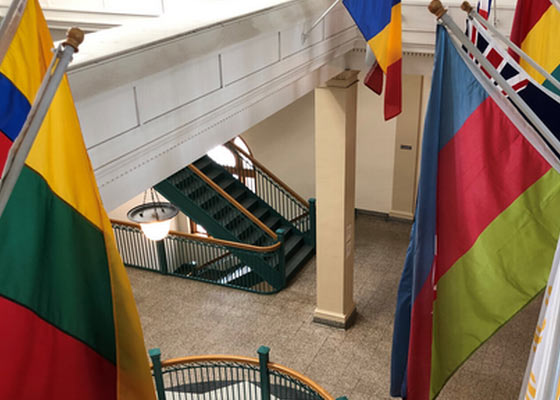 Flags hanging over the second floor hallway in Old Main