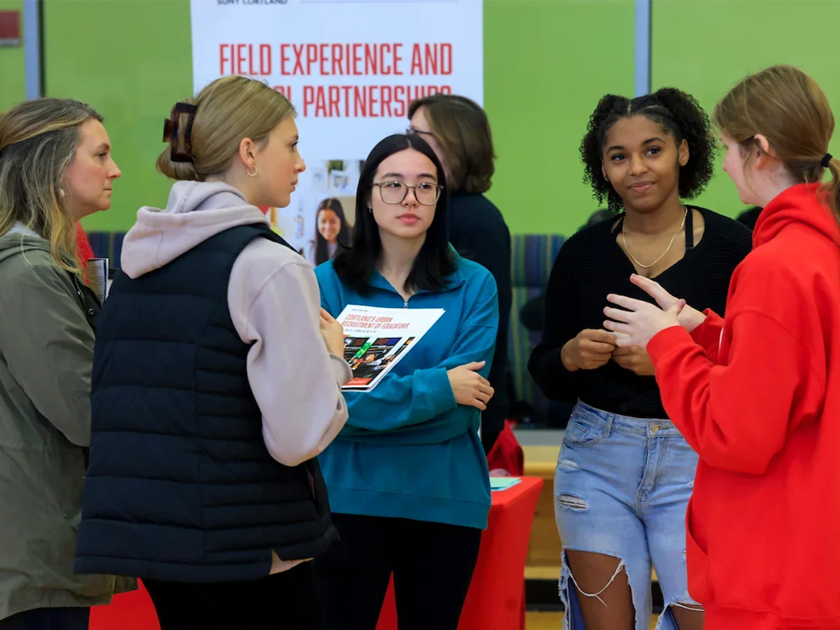 students and families listening at an Open House