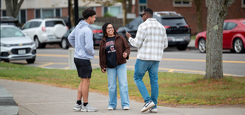 Family candidly laughing on campus