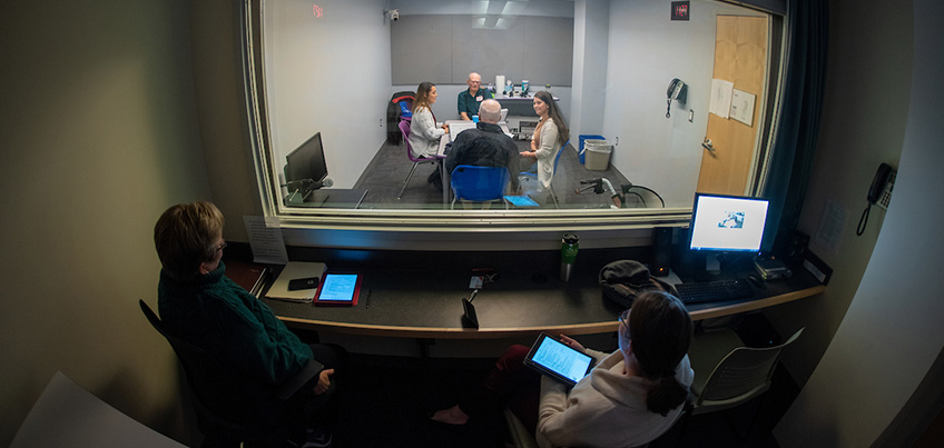 Students working with adults in Center for Speech, Language and Hearing Disorders