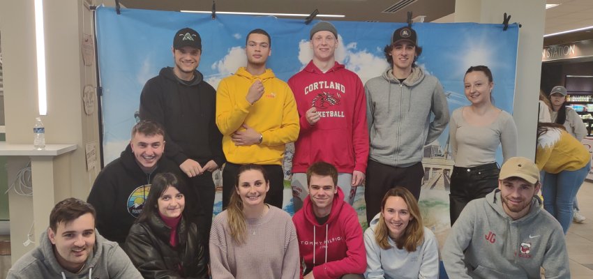 International Students standing in front of a backdrop in Corey Union.