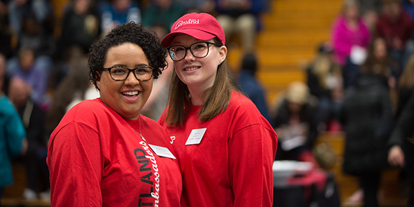 Tour Guides at Spring Open House with students and families in the background