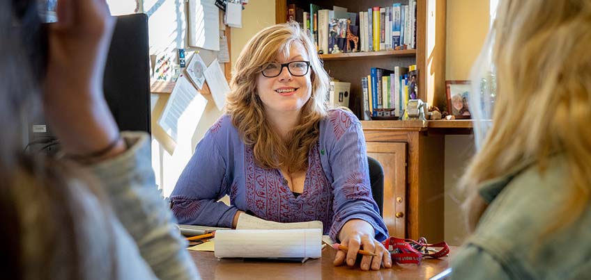 Professor Curtis speaking with students in her office