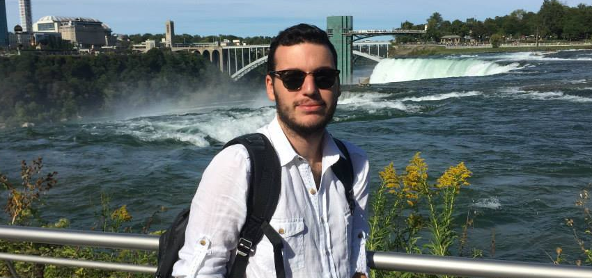 Student standing with Niagara Falls in the background