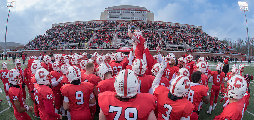 Football team huddle during Cortaca Jug game